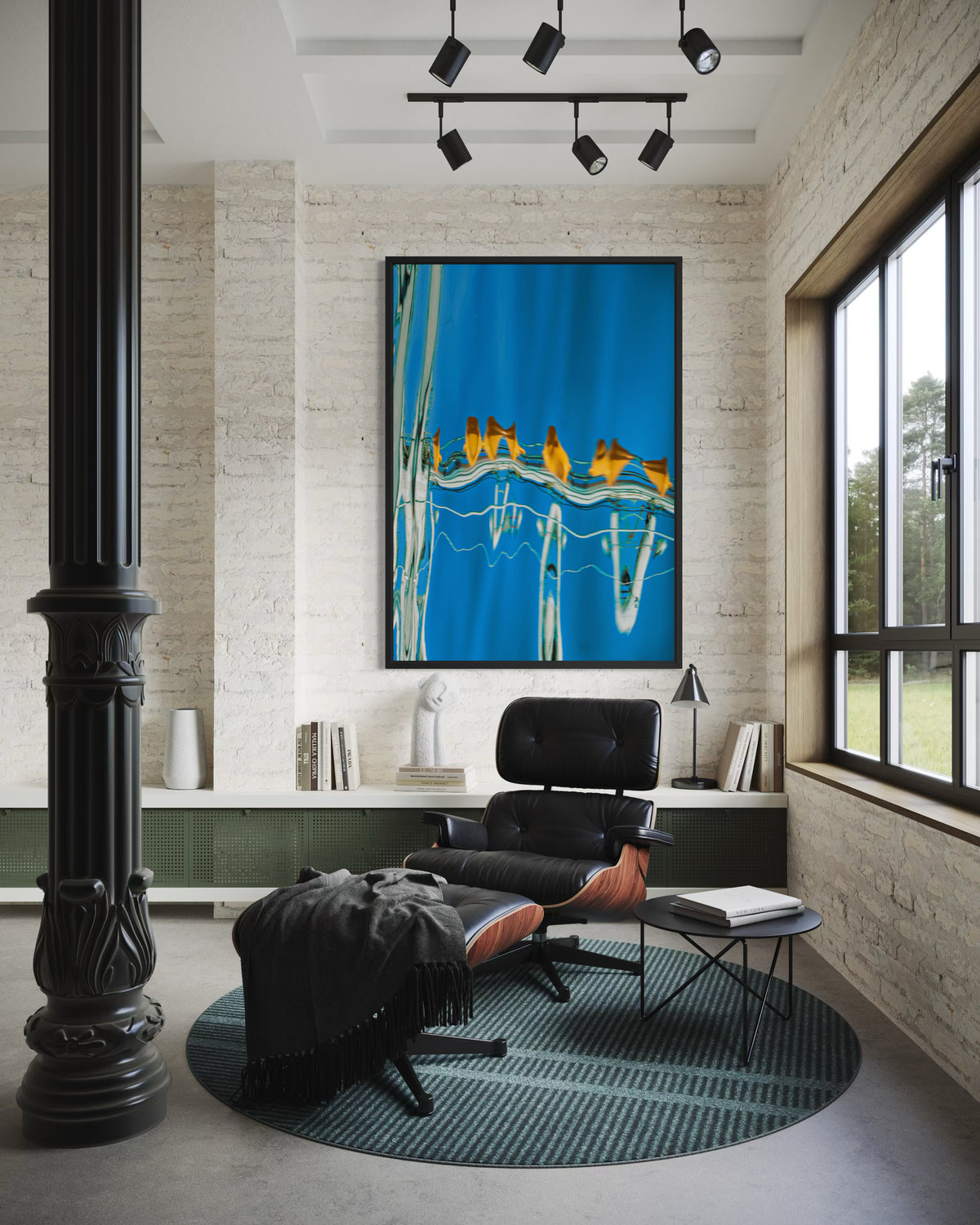 The Water Ballet by Ralph Kerle, in situ, framed above a black lounge chair in a light brick-walled interior.
