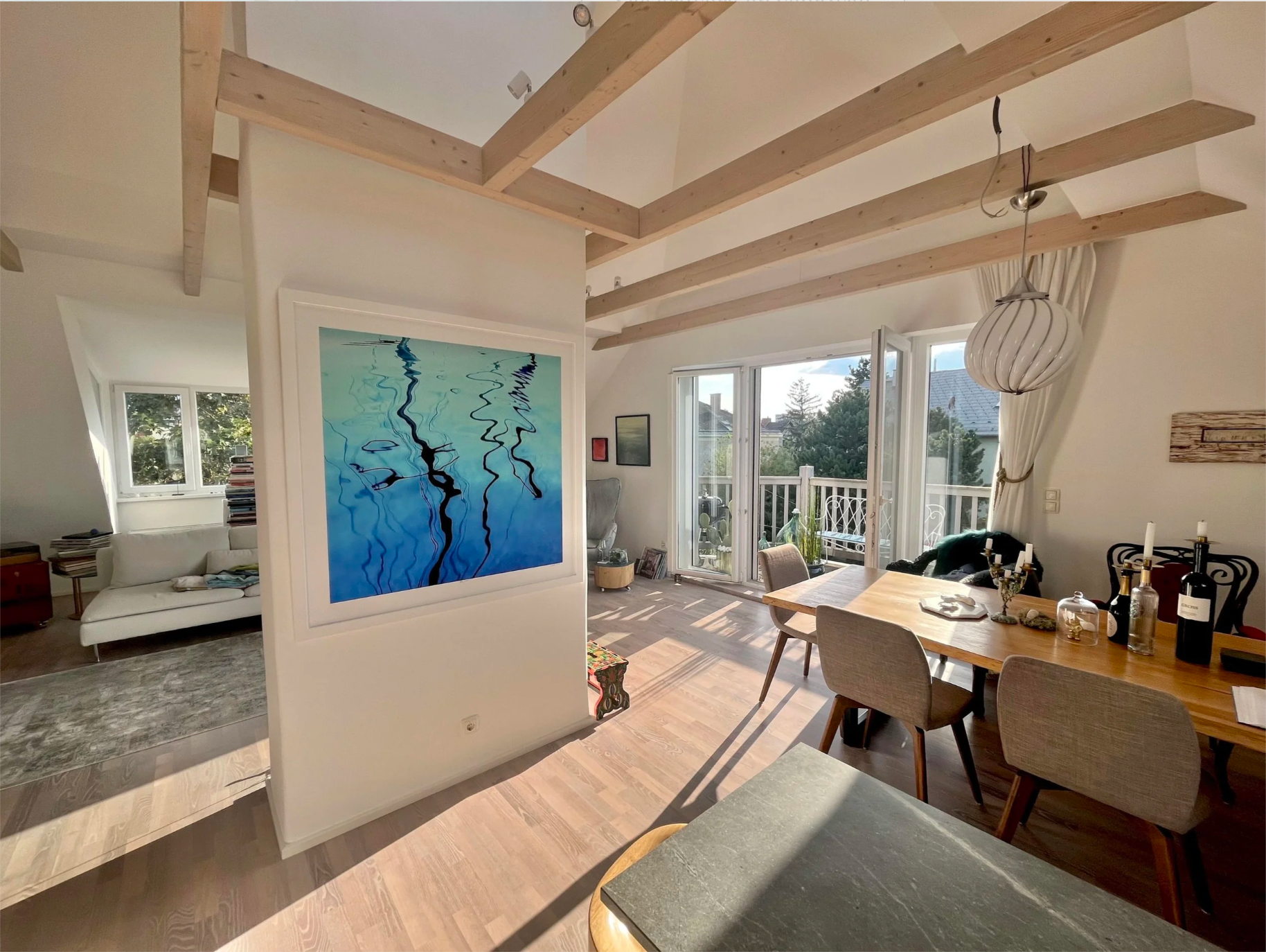 Blue Poles by Ralph Kerle featured in a customer’s residential living room with soft furnishings and personal décor, showing the artwork integrated into a lived-in space