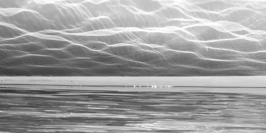 Close-up detail of City of Light artwork showing layered silver tones, rippling water textures and reflected light.
