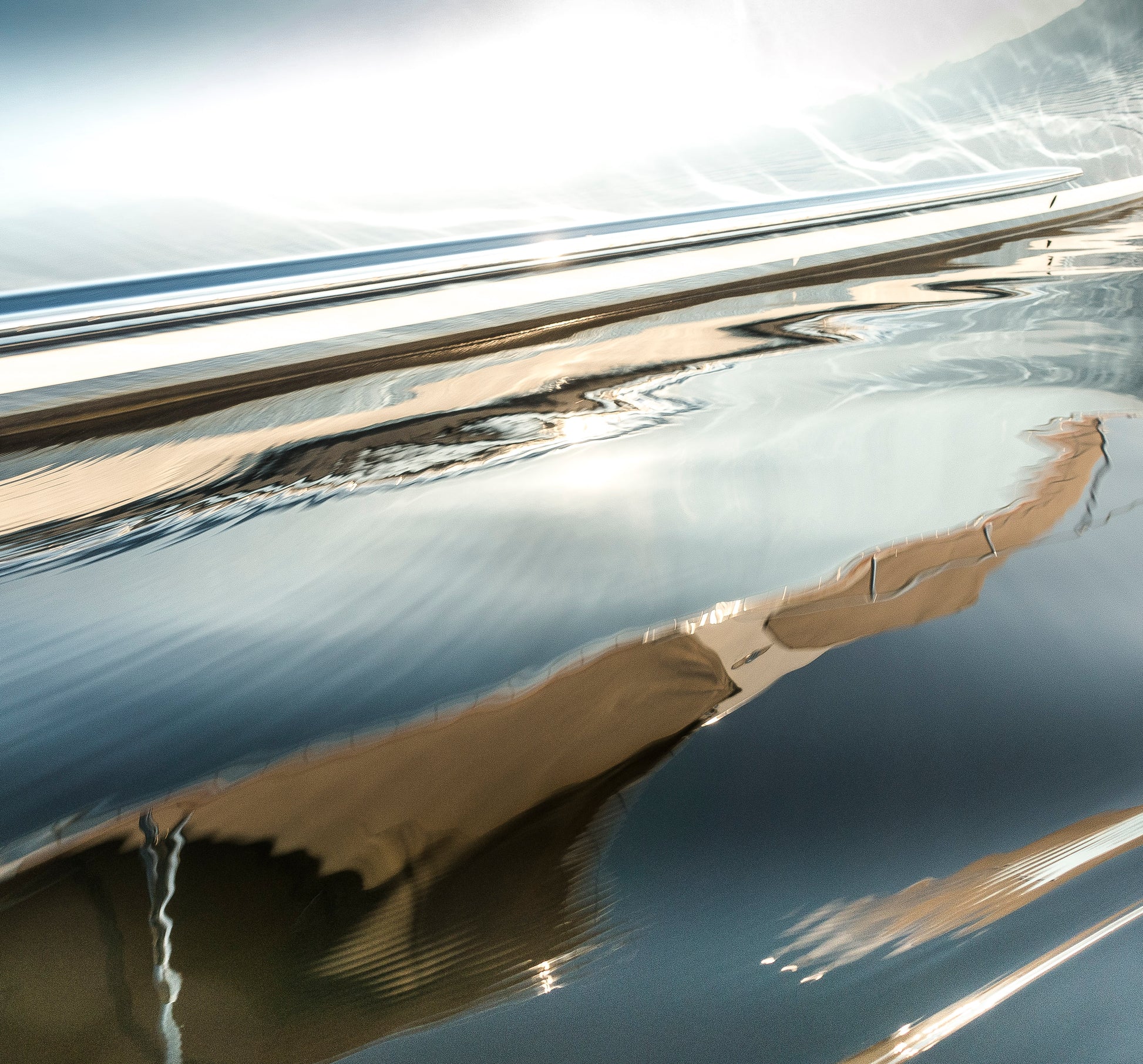 Close-up of a reflective metallic surface with blurred background