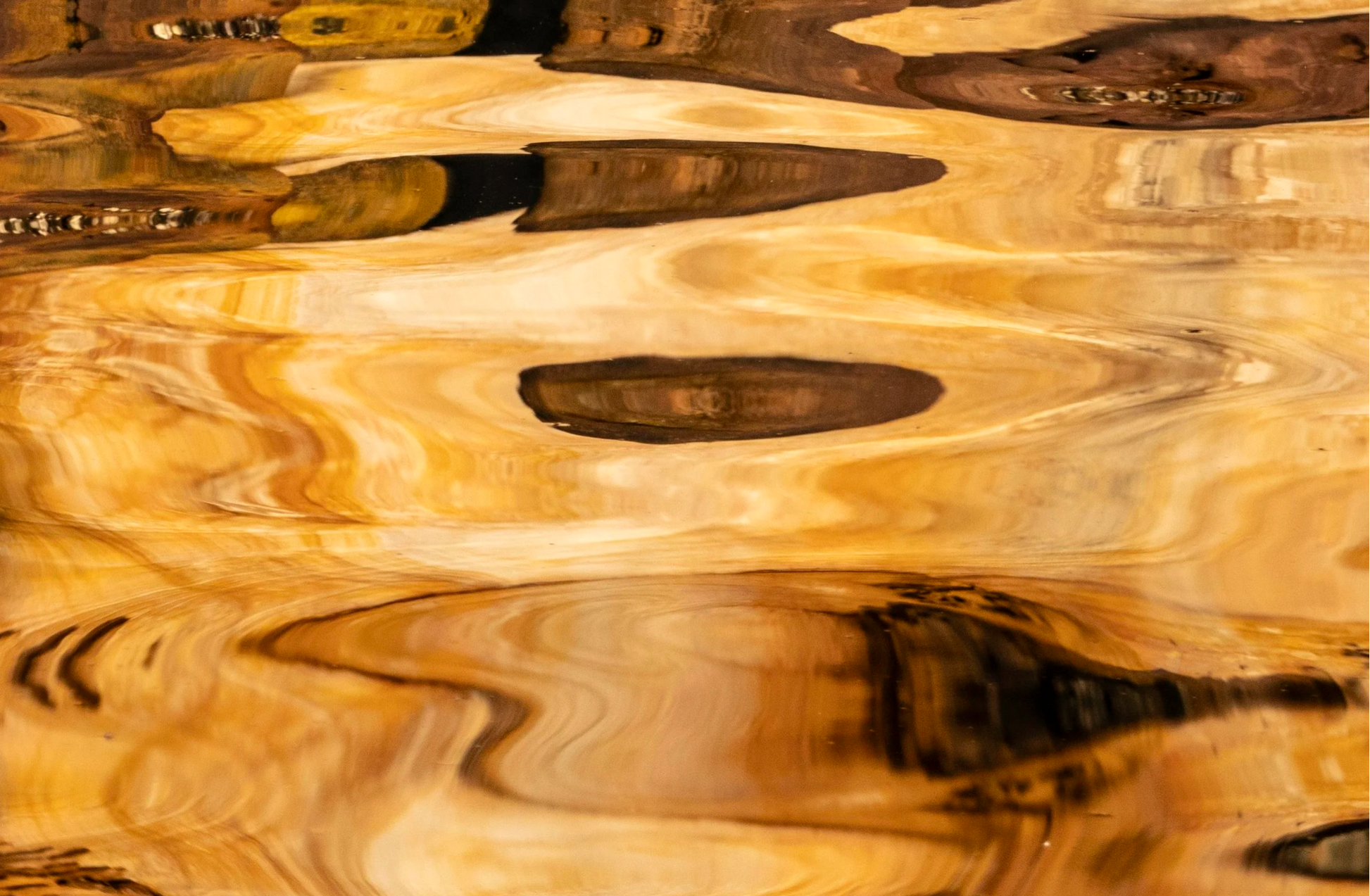 Close-up of a wooden surface with a natural, wavy pattern.