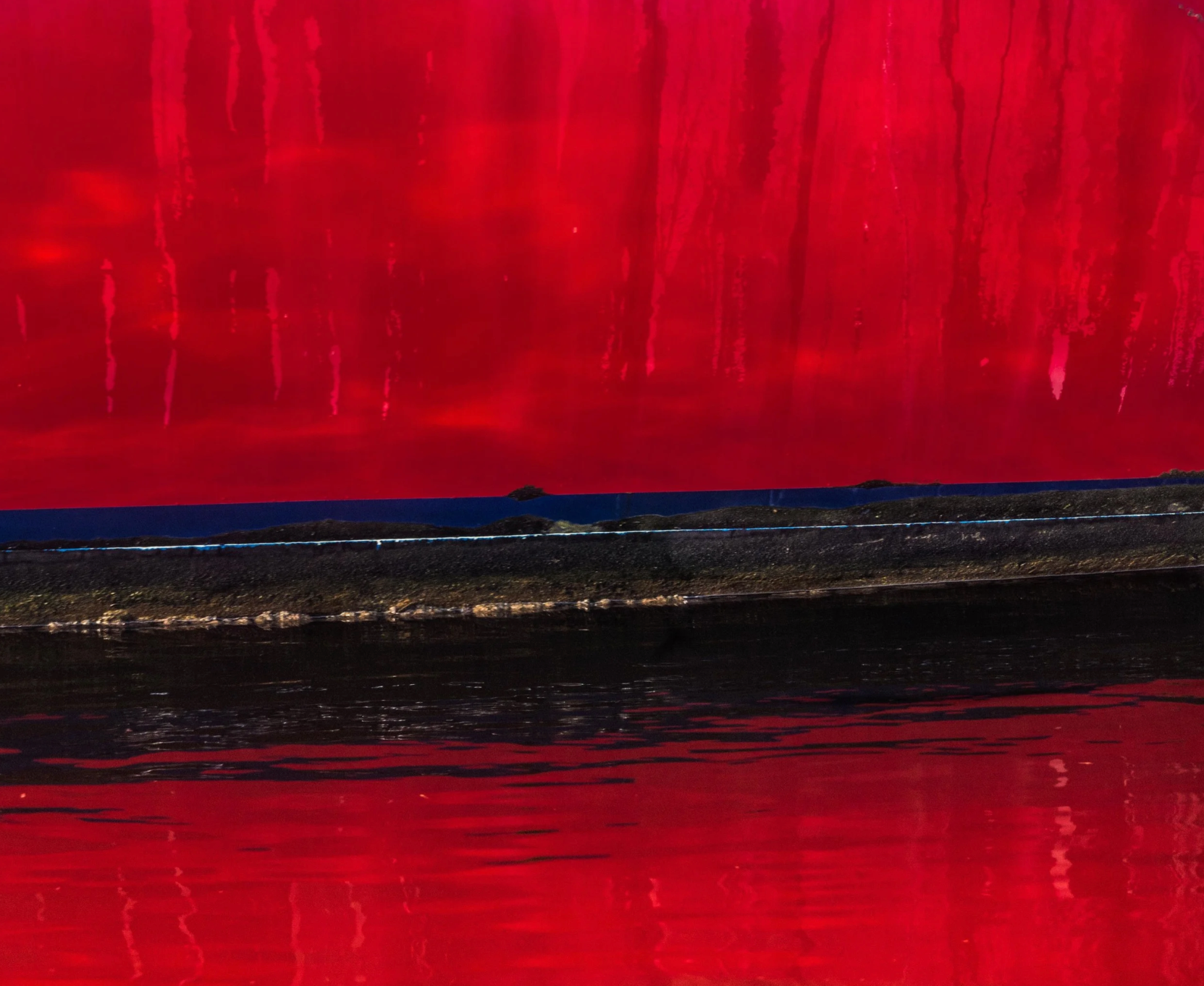 Red abstract painting with a dark base