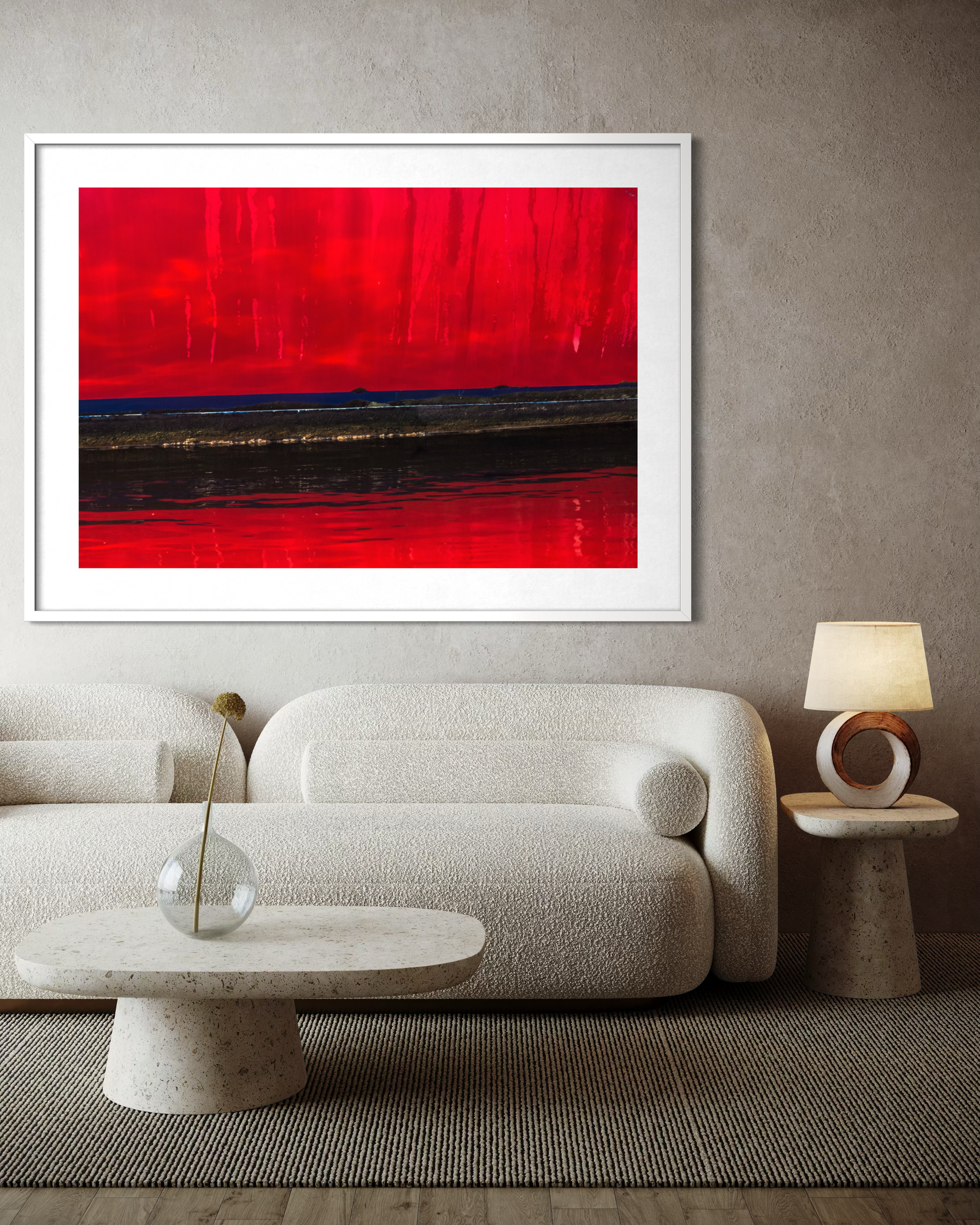Red Rain on the Peace Parade by Ralph Kerle positioned above a sofa in a warm, lived-in living space with layered textiles and decorative accents that balance the bold colours of the painting