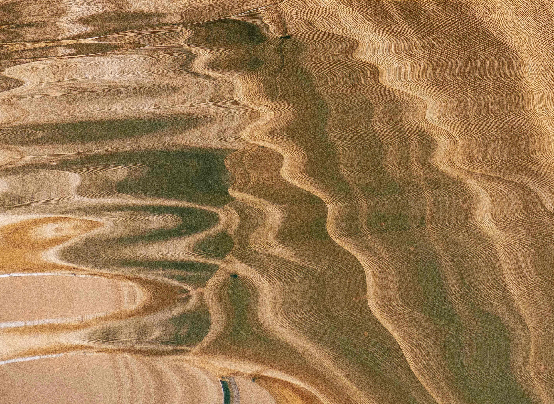 Wavy sand patterns on a beach