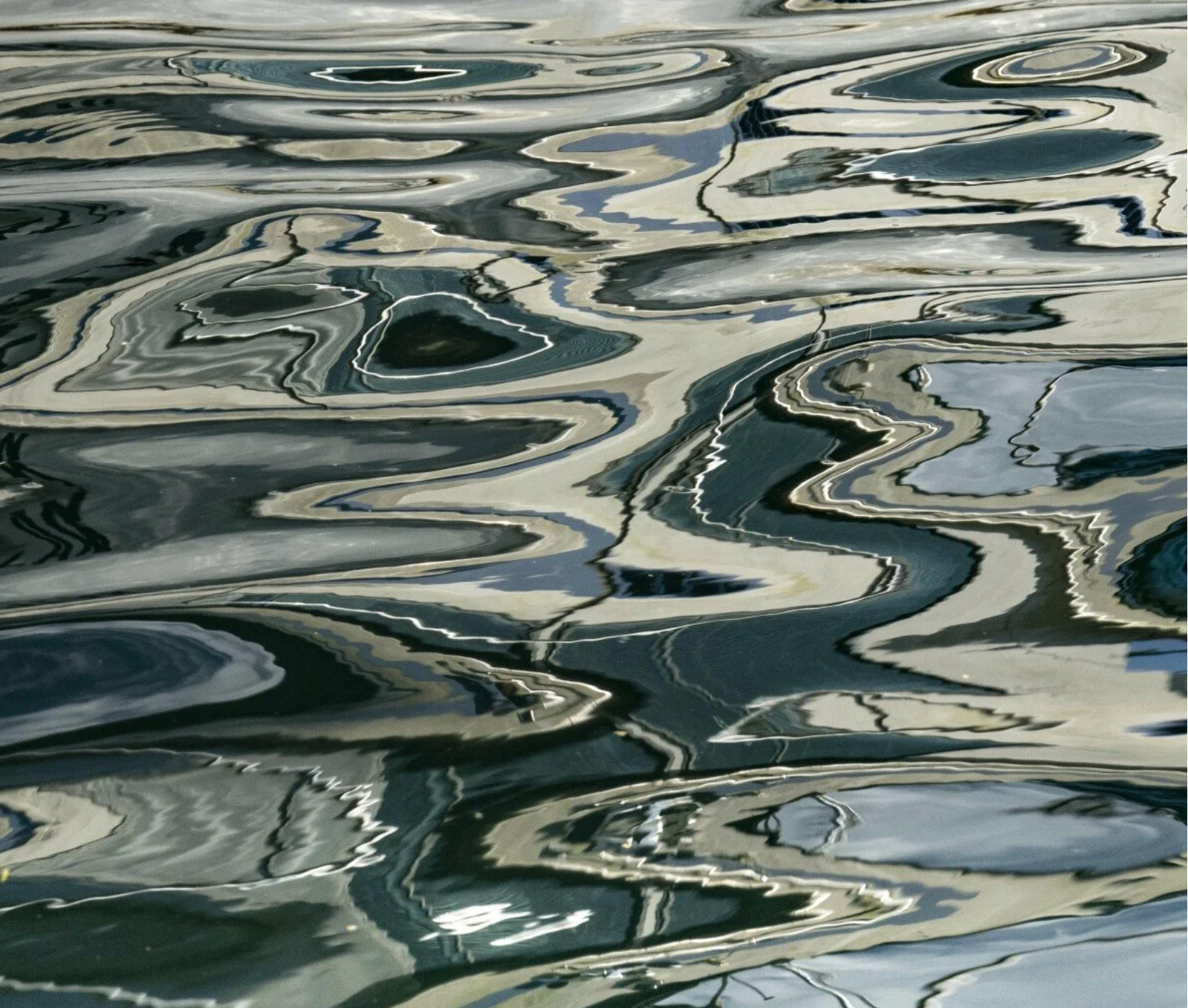 Abstract pattern of wavy lines and shapes in gray and white tones.