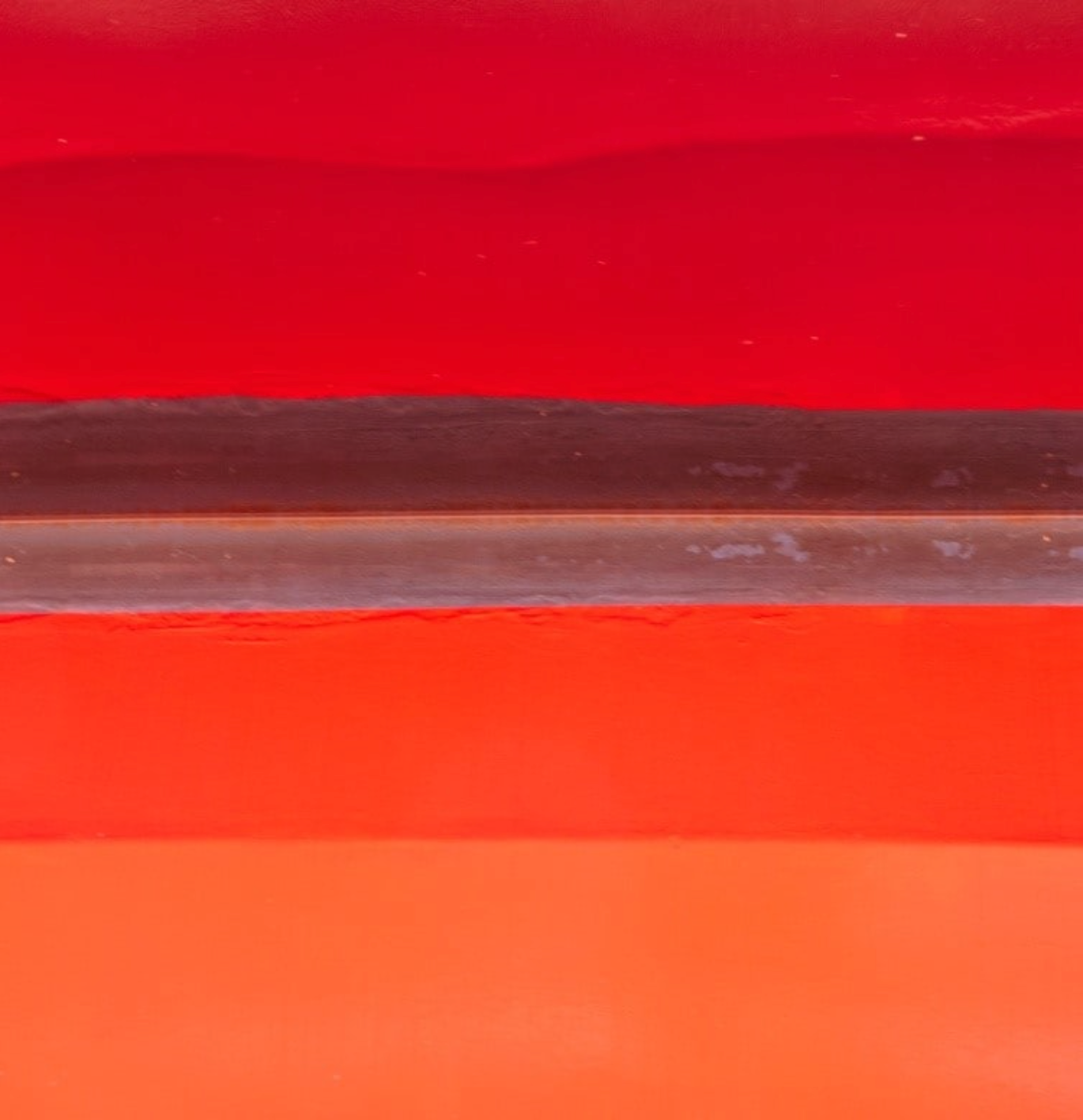 Close-up of a red and orange gradient with a black line running horizontally.